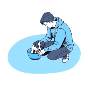 A person caring for a puppy inside a bowl.